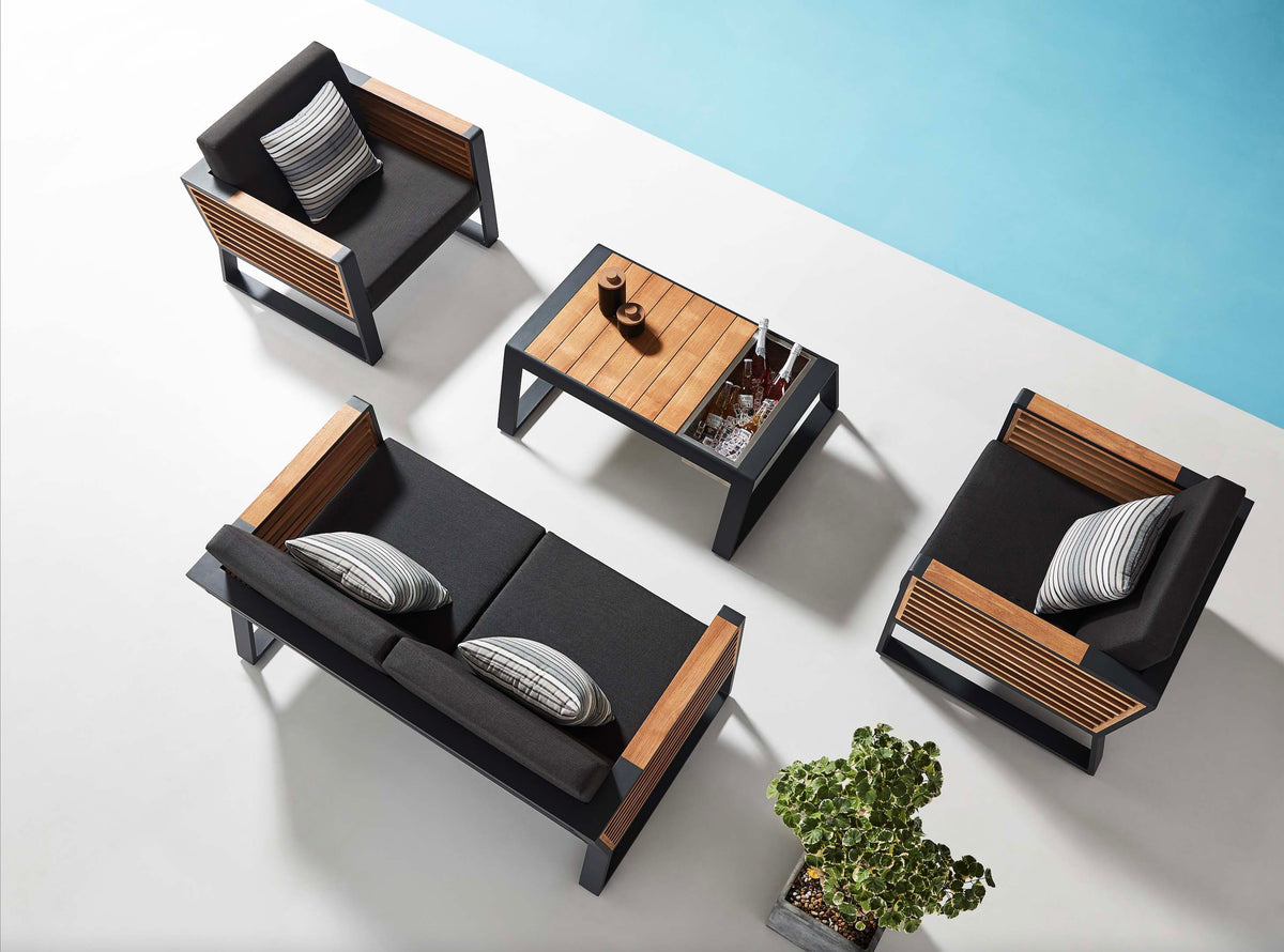 Cofy Mini black aluminum loveseat patio set with teak cooler coffee table – shown outdoors (4)
