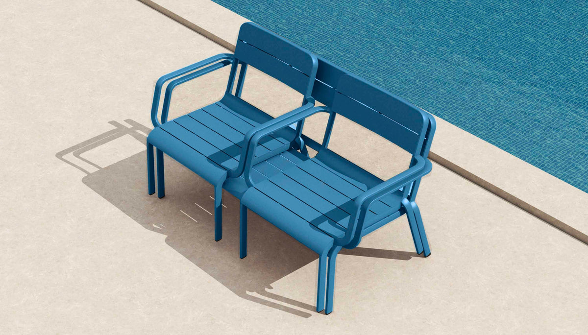 Joy stackable aluminum patio set in blue with loveseat and armchairs – shown outdoors