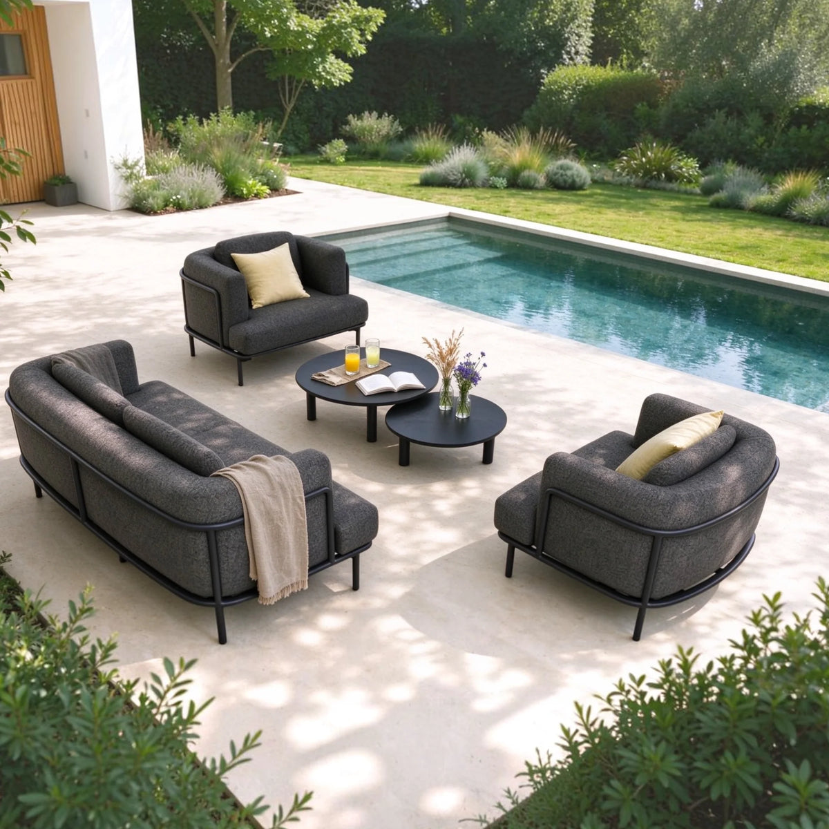 Flora anthracite aluminum loveseat set upholstered in black boucle – shown outdoors