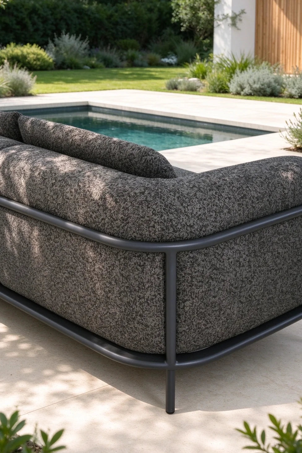 Flora anthracite aluminum loveseat set upholstered in black boucle – shown outdoors (3)