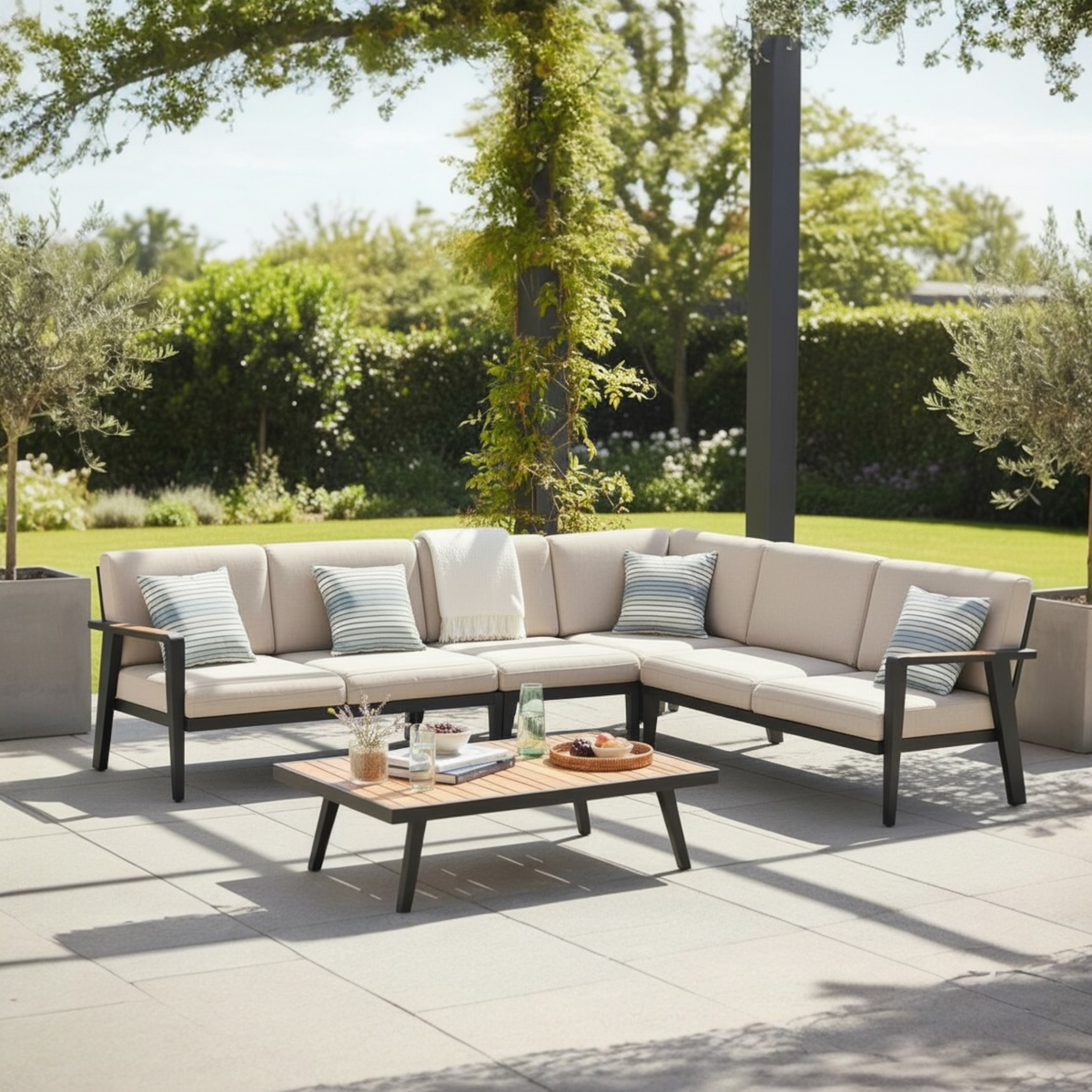 Lovy Cosy black aluminum outdoor sectional with solid teak armrests – shown outdoors