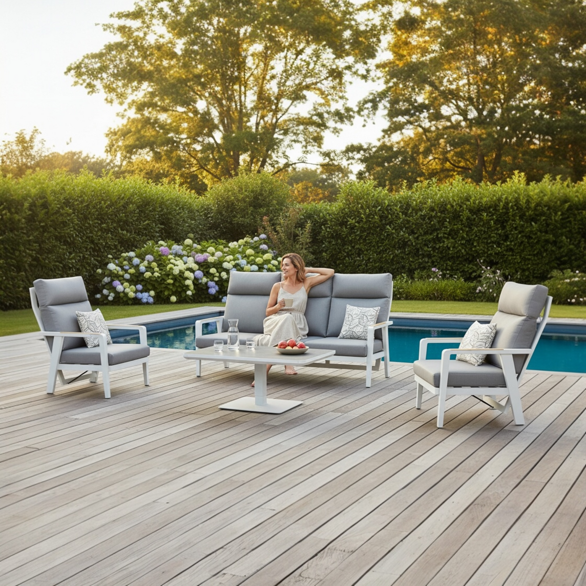 Marius white aluminum patio set with reclining armchairs and lift-top table – shown outdoors
