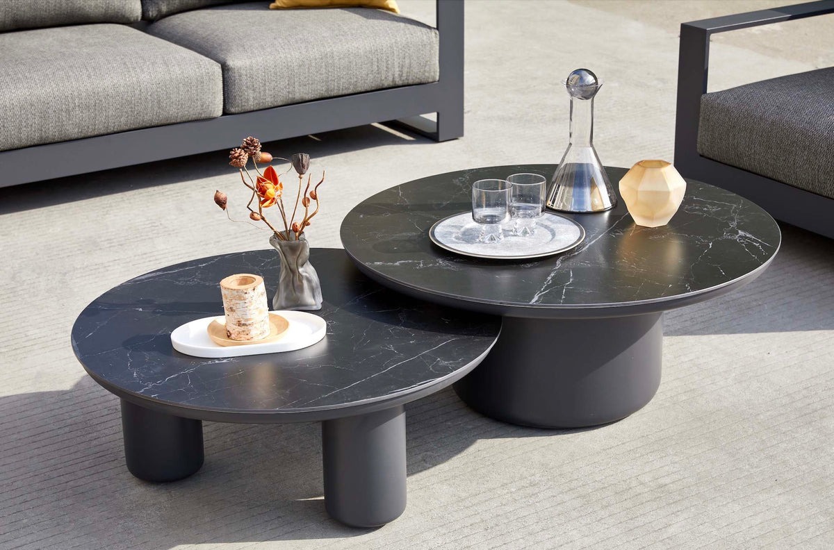 Coffee table from the Iris Bis black modular aluminum patio set with gray cushions and ceramic tables – close-up detail