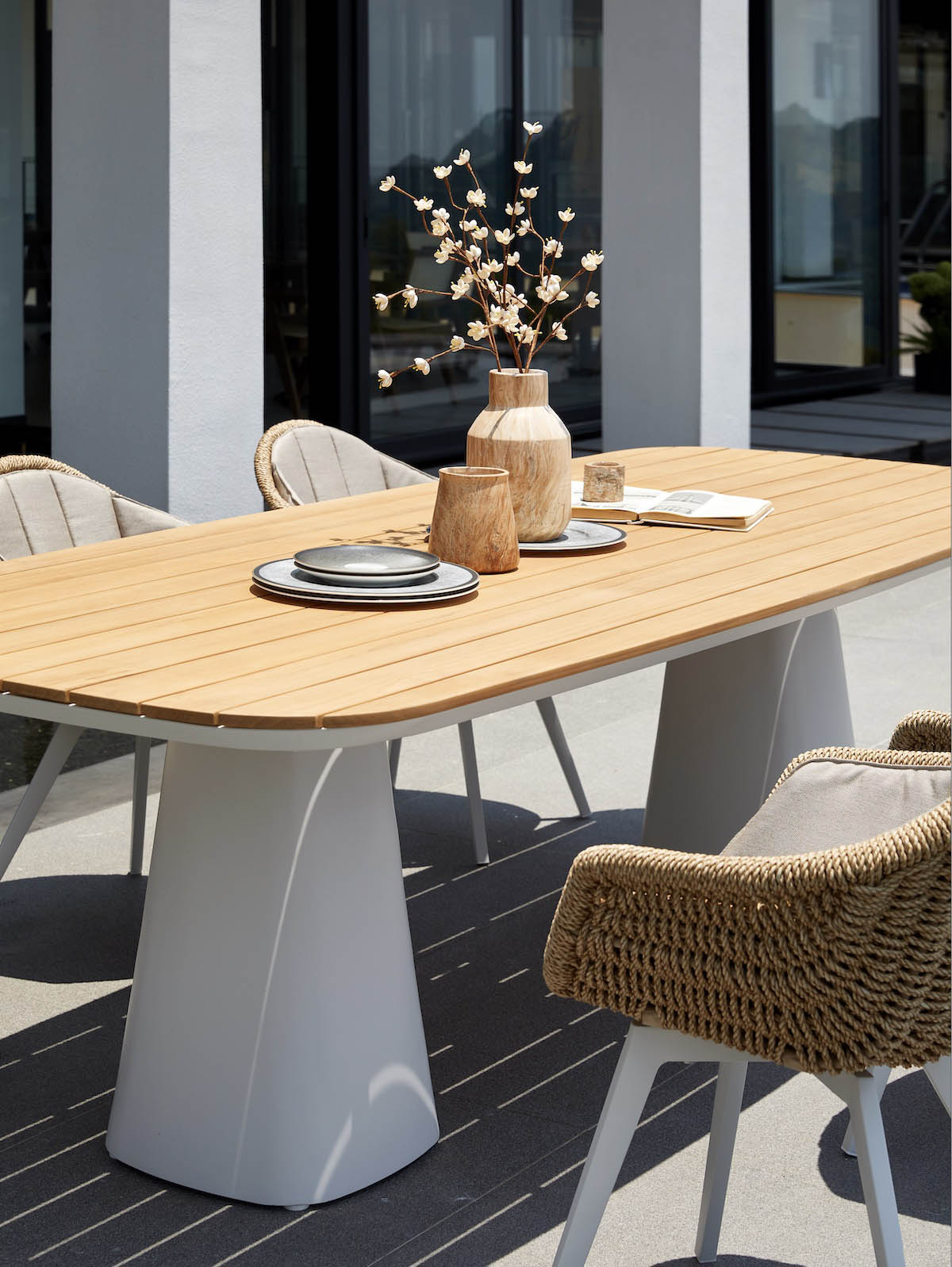 Milo teak-top aluminum outdoor dining table for eight – shown outdoors (4)