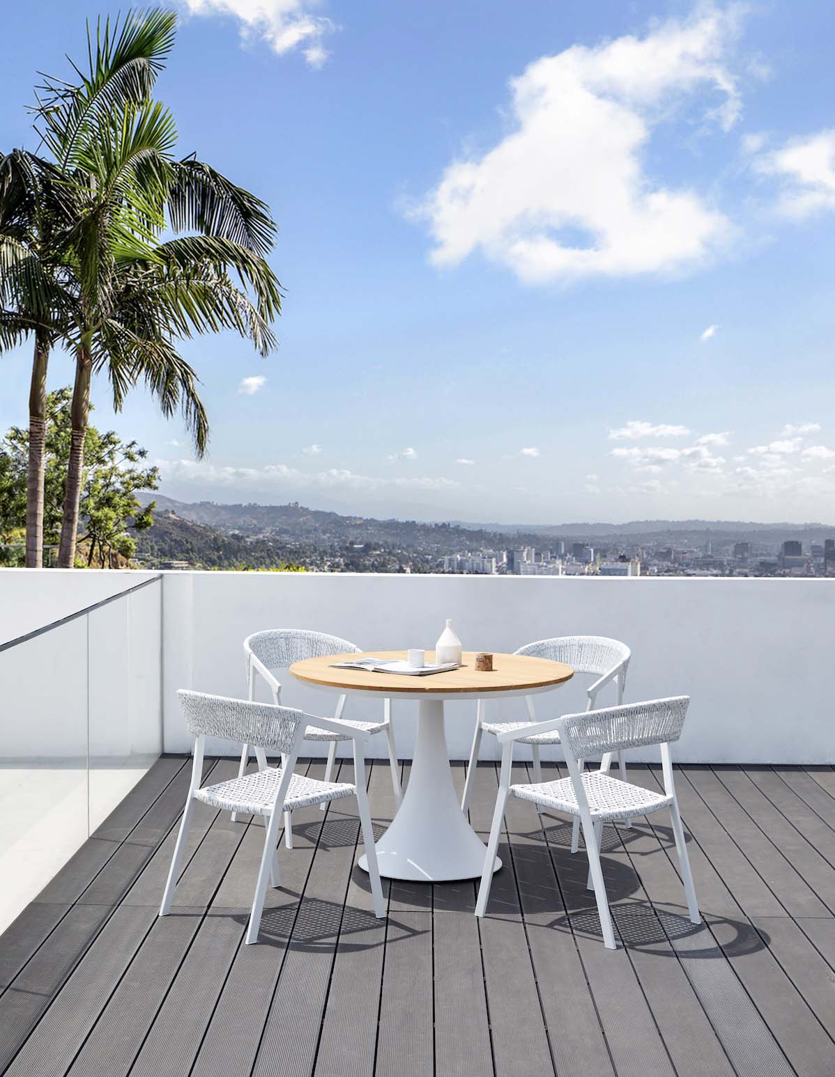 Fano white aluminum round teak-top patio table – shown outdoors (4)
