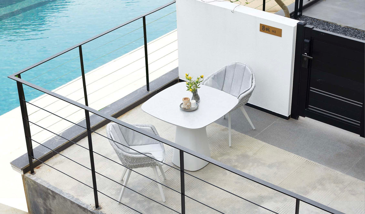 Milo square gray ceramic aluminum outdoor dining table – shown outdoors (5)