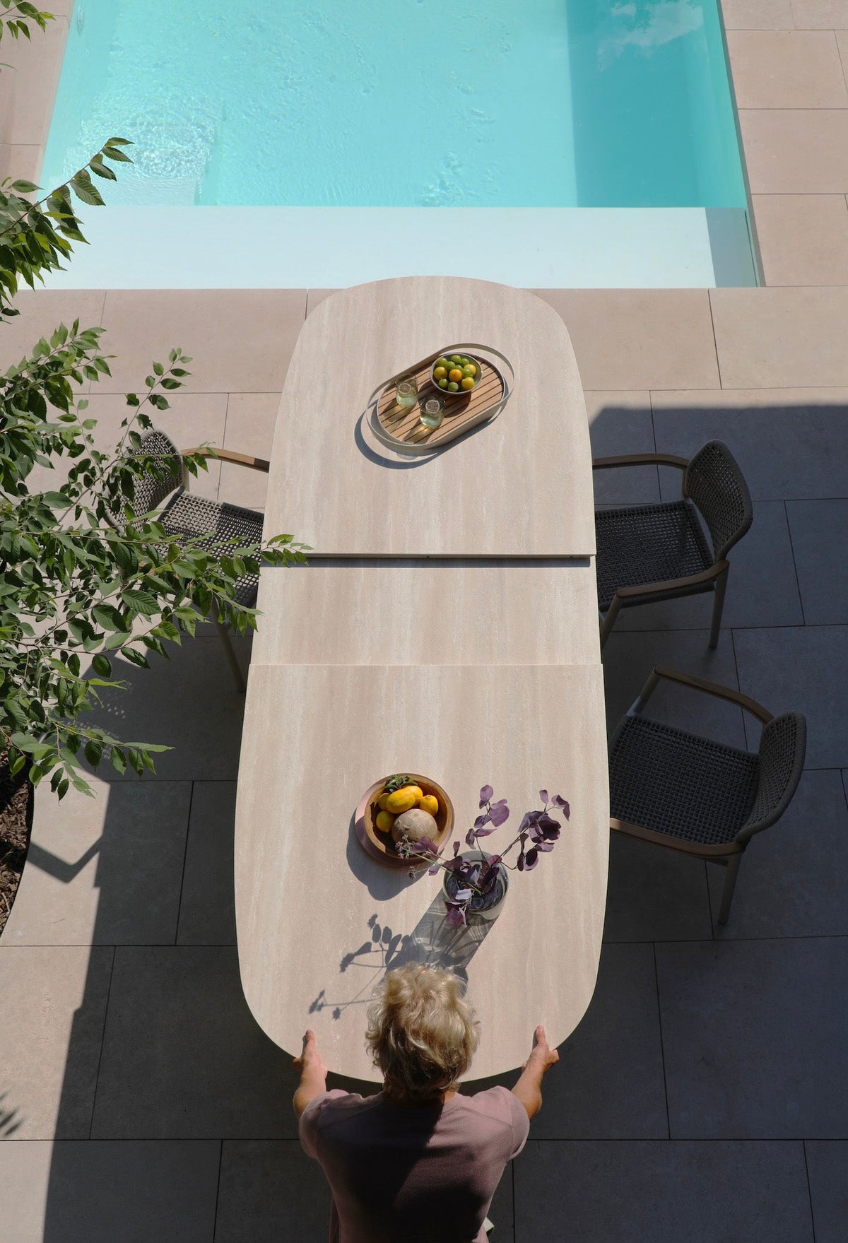 Livio beige oval extendable ceramic outdoor dining table – shown outdoors (3)