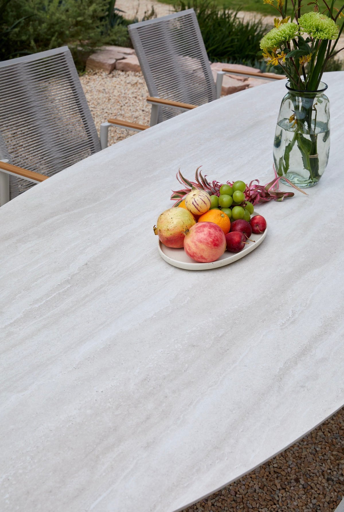 Nino glossy ceramic oval outdoor dining table – shown outdoors (9)