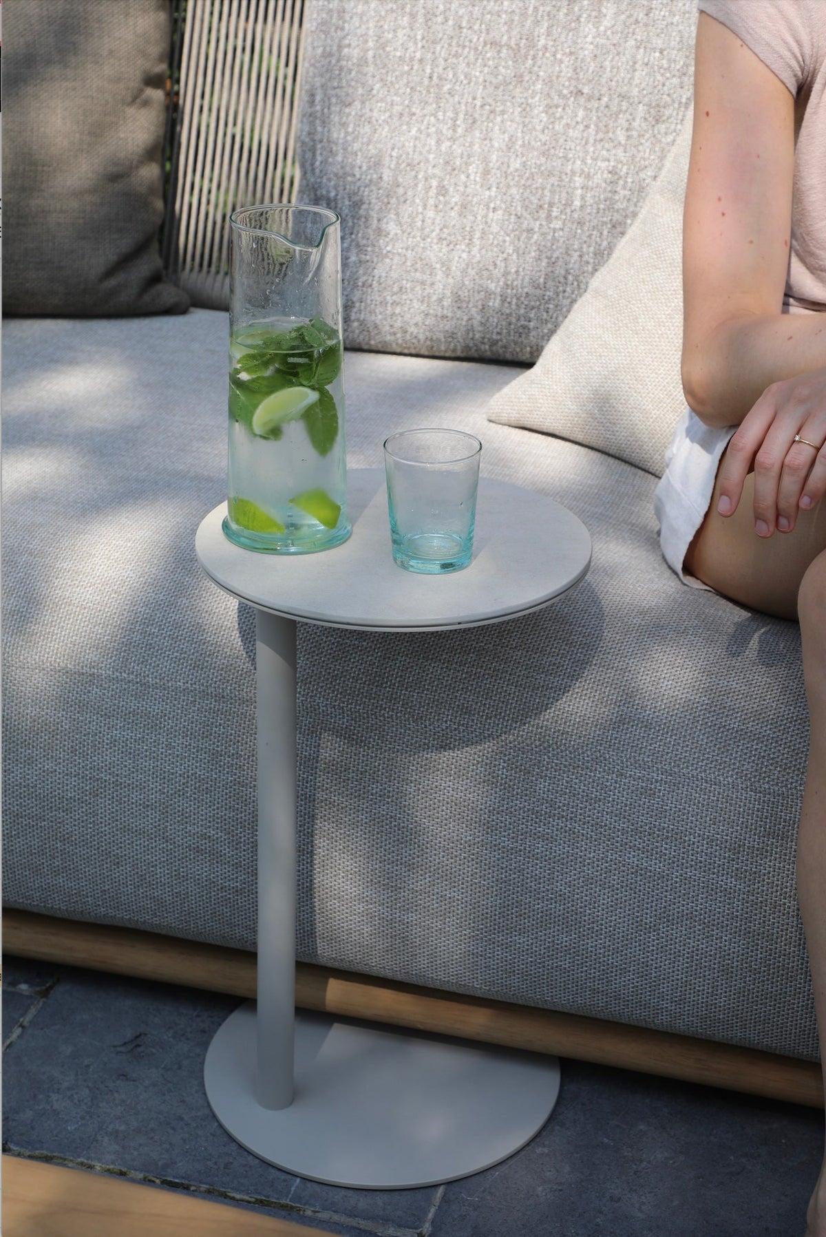Bulter beige aluminum round ceramic side table – shown outdoors (3)