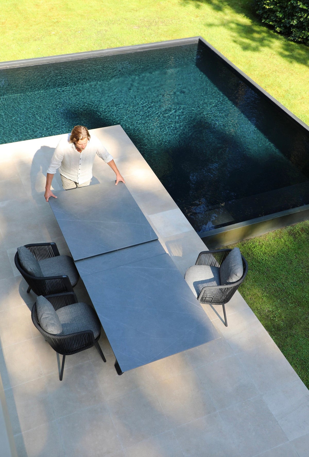 Livio ceramic-top aluminum outdoor dining table with sliding extension – shown outdoors (3)