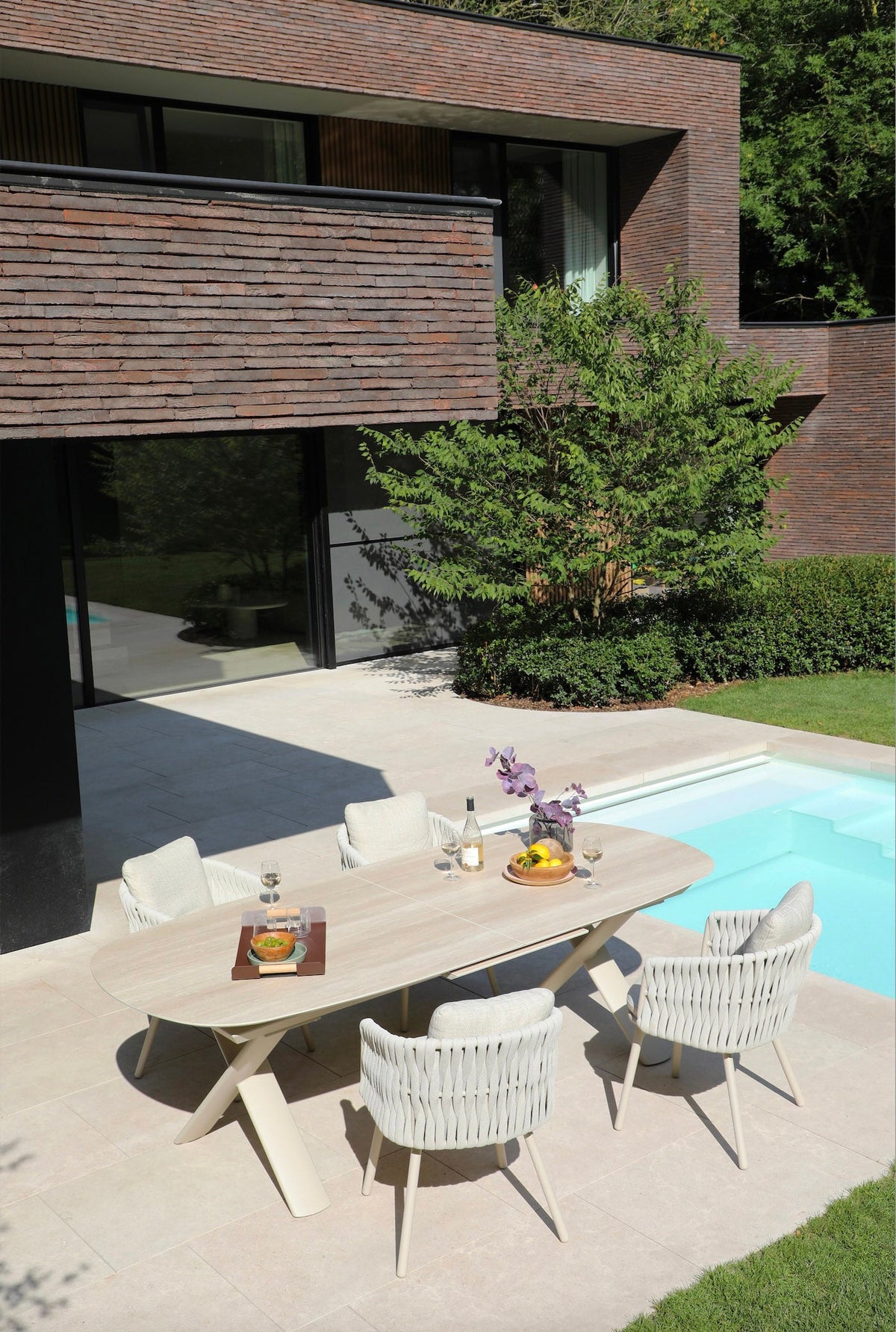 Livio beige aluminum and rope outdoor dining armchair – shown outdoors (4)