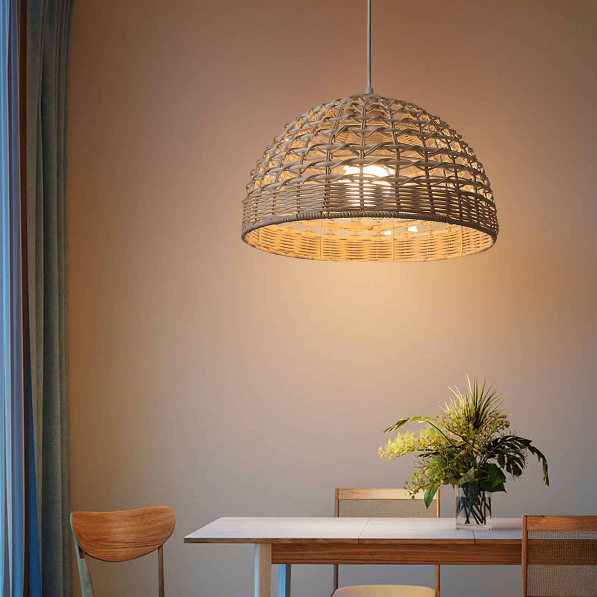 Ovoid handwoven rattan and wicker pendant shade – shown lit in a room setting