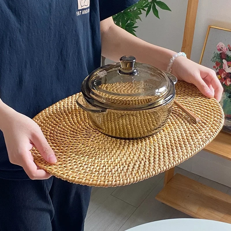 Round handwoven natural rattan trivet – shown in use