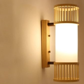 Handwoven cylindrical rattan wall sconce – shown lit
