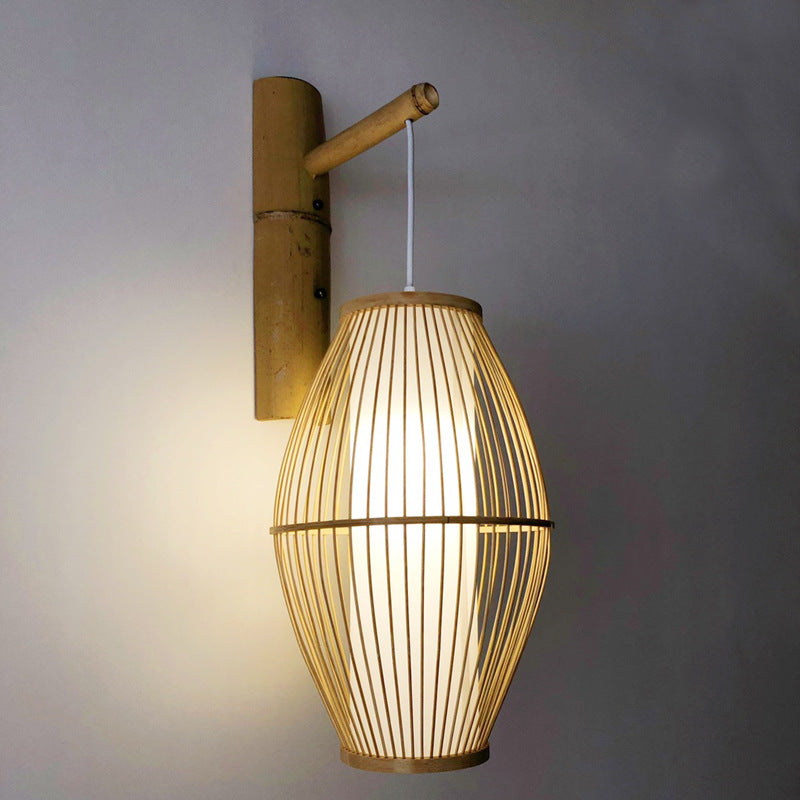 Oval openwork handwoven rattan wall sconce – shown lit