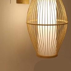 Oval openwork handwoven rattan wall sconce – shown lit (2)
