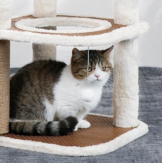 Rattan cat tree with soft plush covers – shown in a room setting