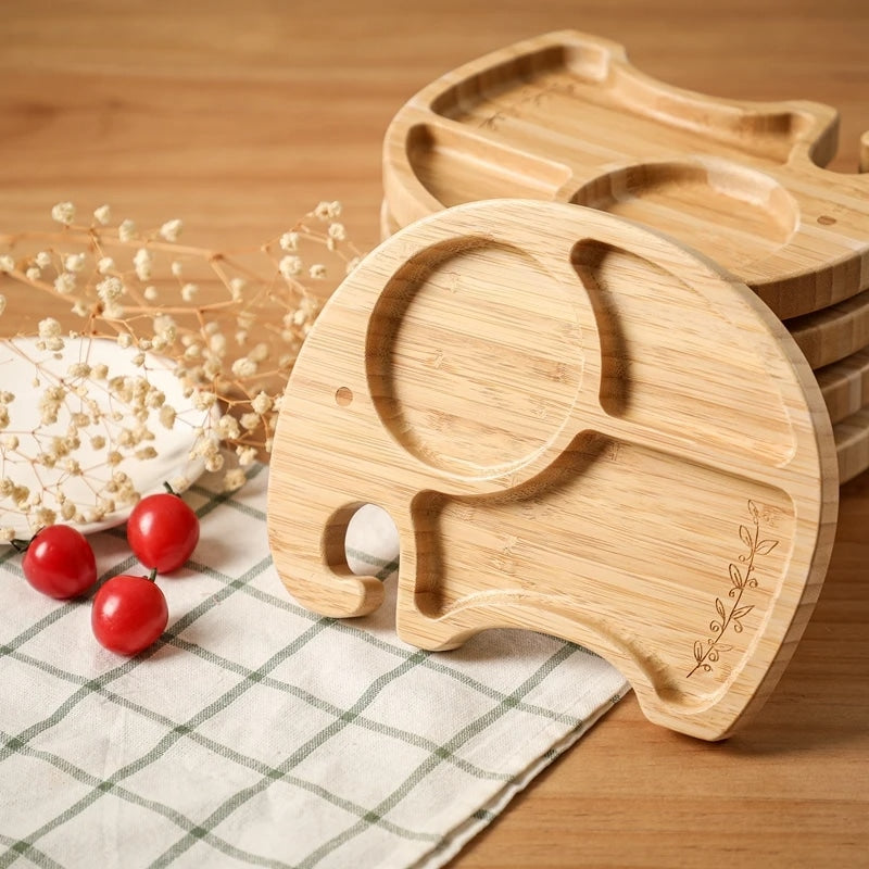 Elephant-shaped bamboo kids plate with a matching spoon – shown in a room setting