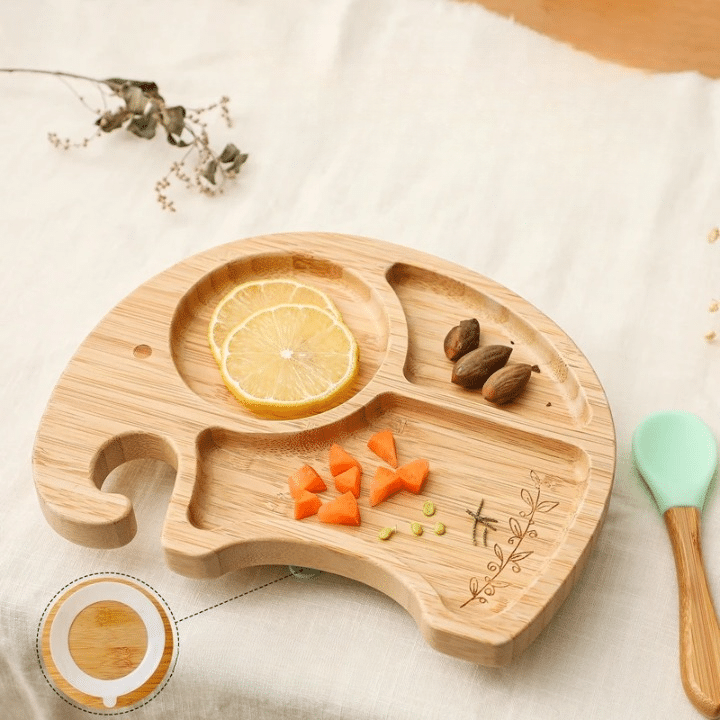 Elephant-shaped bamboo kids plate with a matching spoon – shown in a room setting (2)