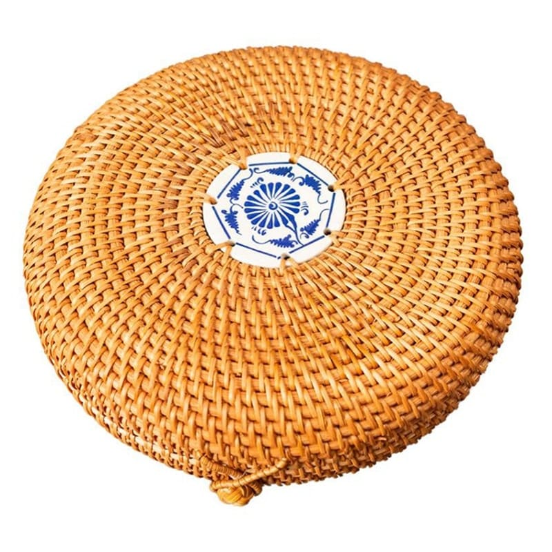 Round woven rattan jewelry box with a geometric pattern and lid