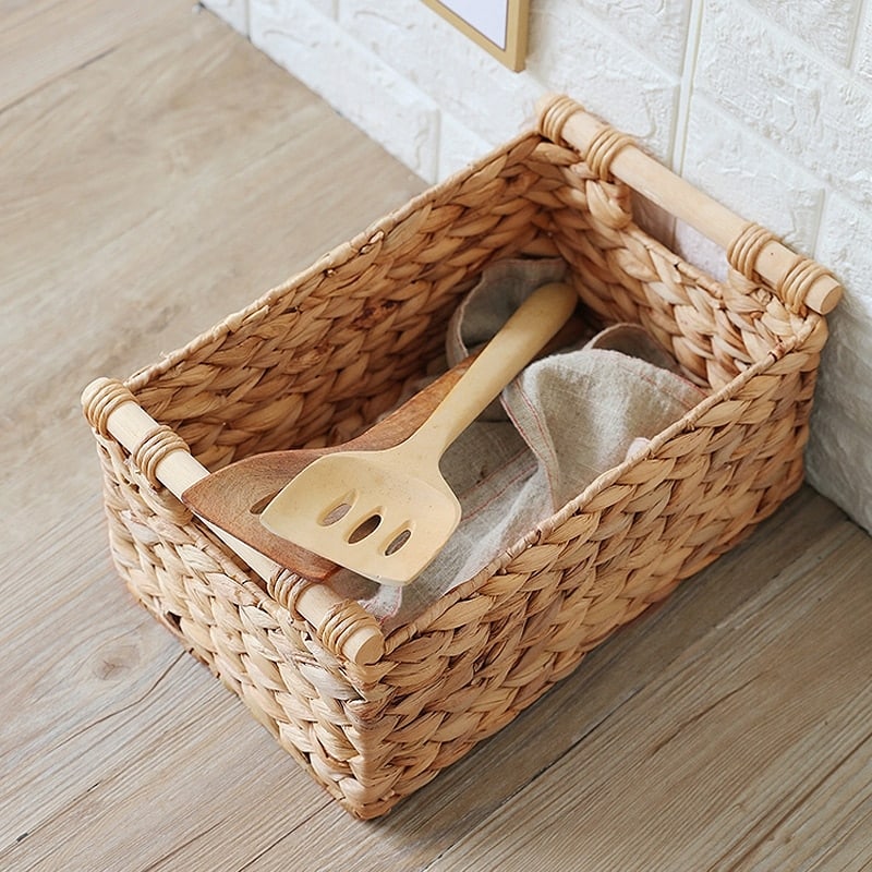 Woven rattan storage box with two sturdy handles – shown in a room setting