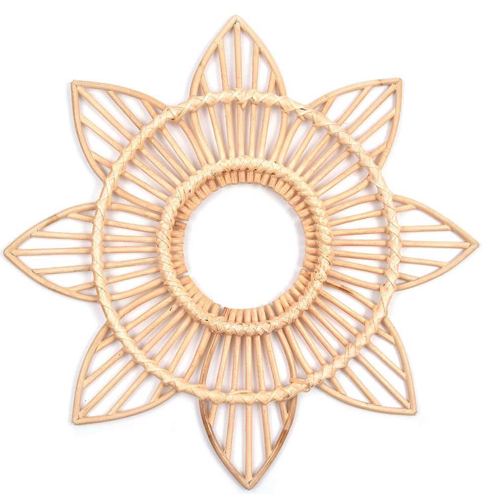 Sun motif rattan frame with hand-braided radiating stems