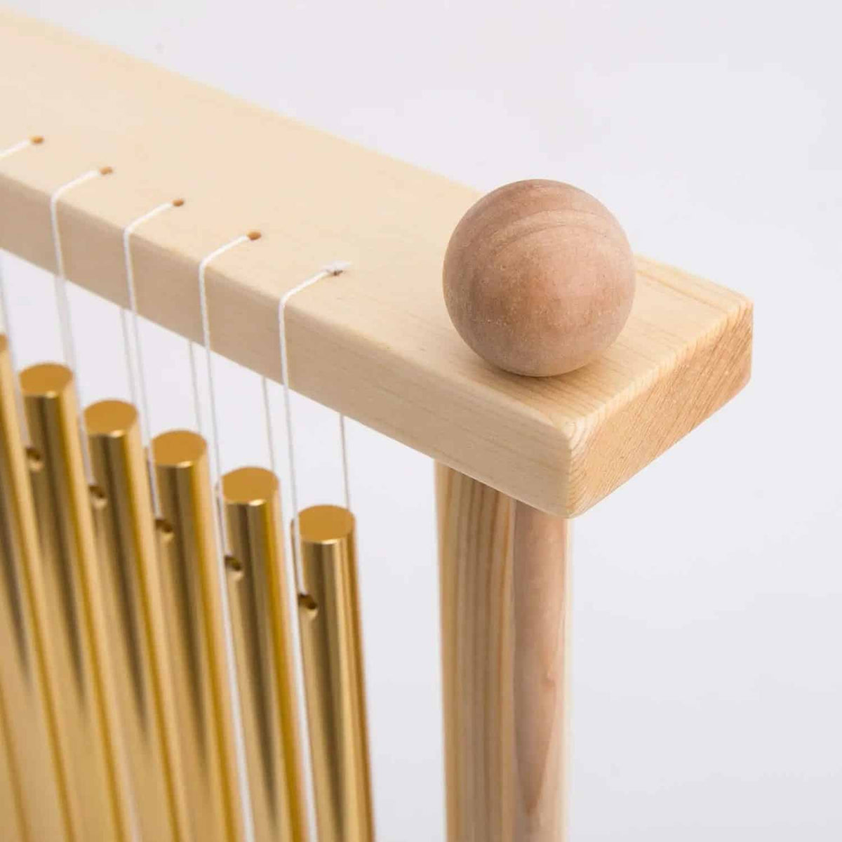 Sturdy bamboo wind chime with golden tubes – close-up detail