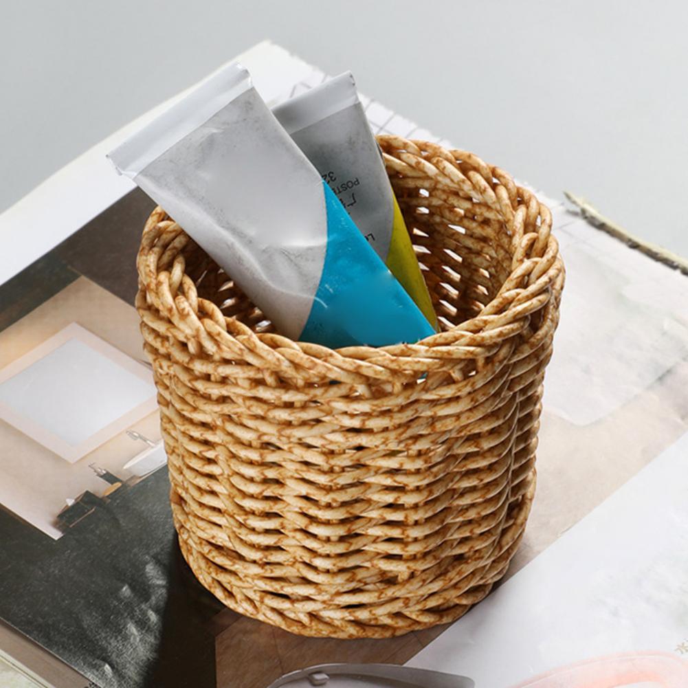 Small round handwoven rattan basket used as a pencil holder