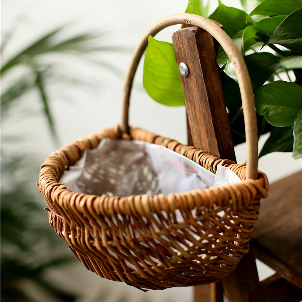 Handwoven natural rattan hanging plant basket – shown outdoors