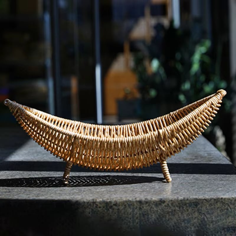 Handwoven natural rattan banana-shaped basket – shown in a room setting (3)
