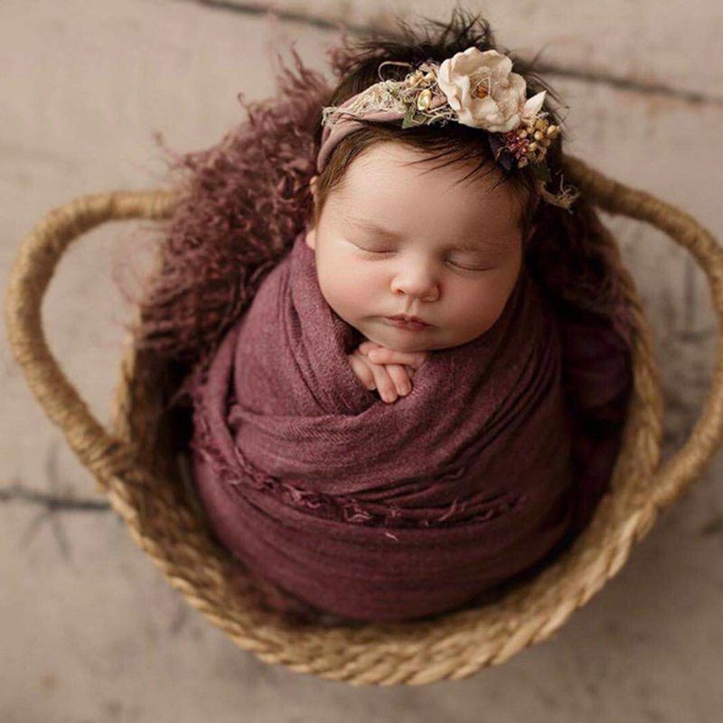 Round hand-braided rattan moses basket – shown in use