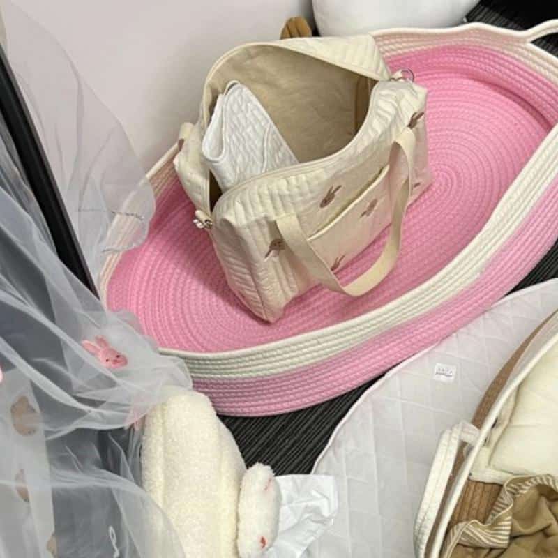 Pink and white synthetic rattan moses basket – close-up detail