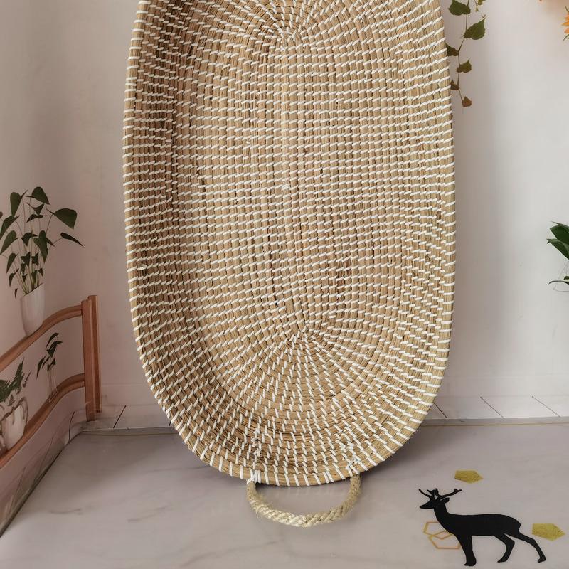 Braided rattan moses basket with integrated handles – close-up detail