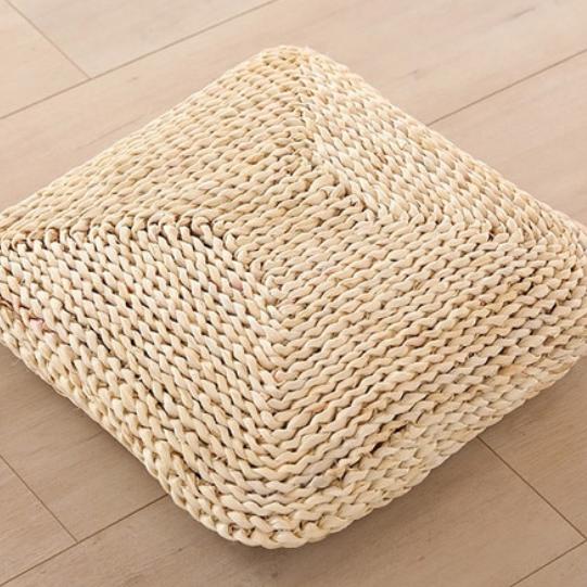 Light square woven rattan seat pad – shown in a room setting