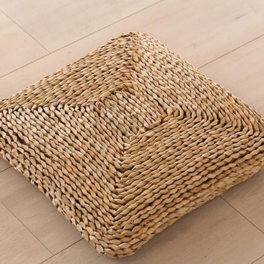 Dark square hand-braided rattan seat pad – shown in a room setting