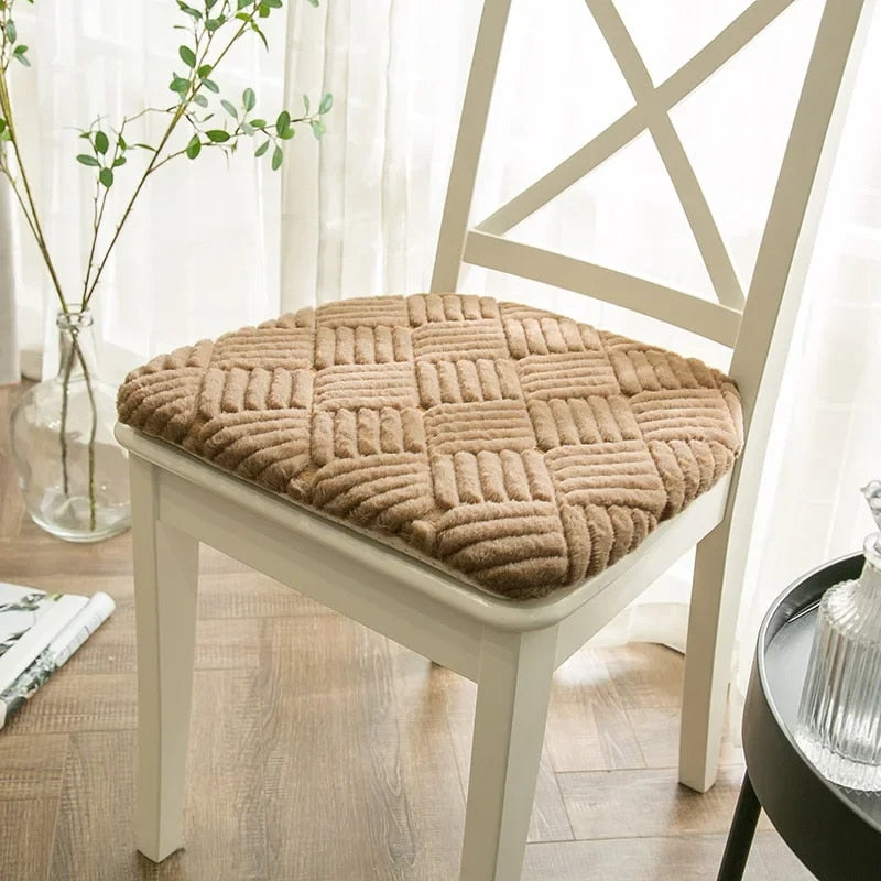 Thick round plush chair cushion with a rattan-look weave – brown variant, shown in a room setting