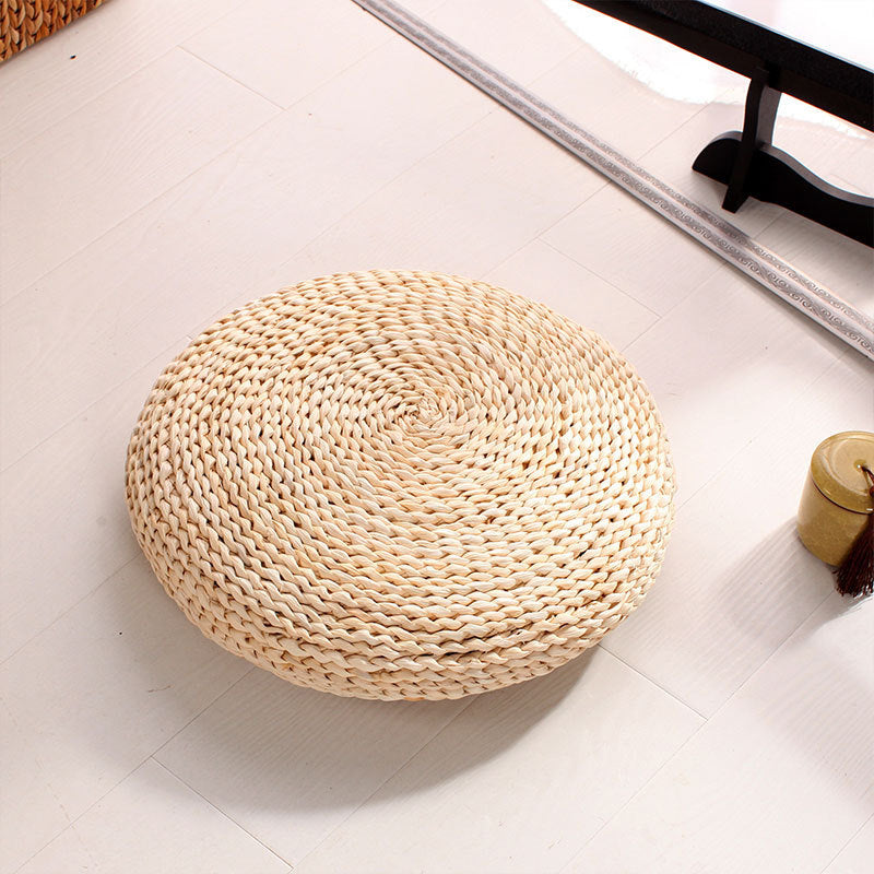 Round light woven rattan cushion – shown in a room setting (2)