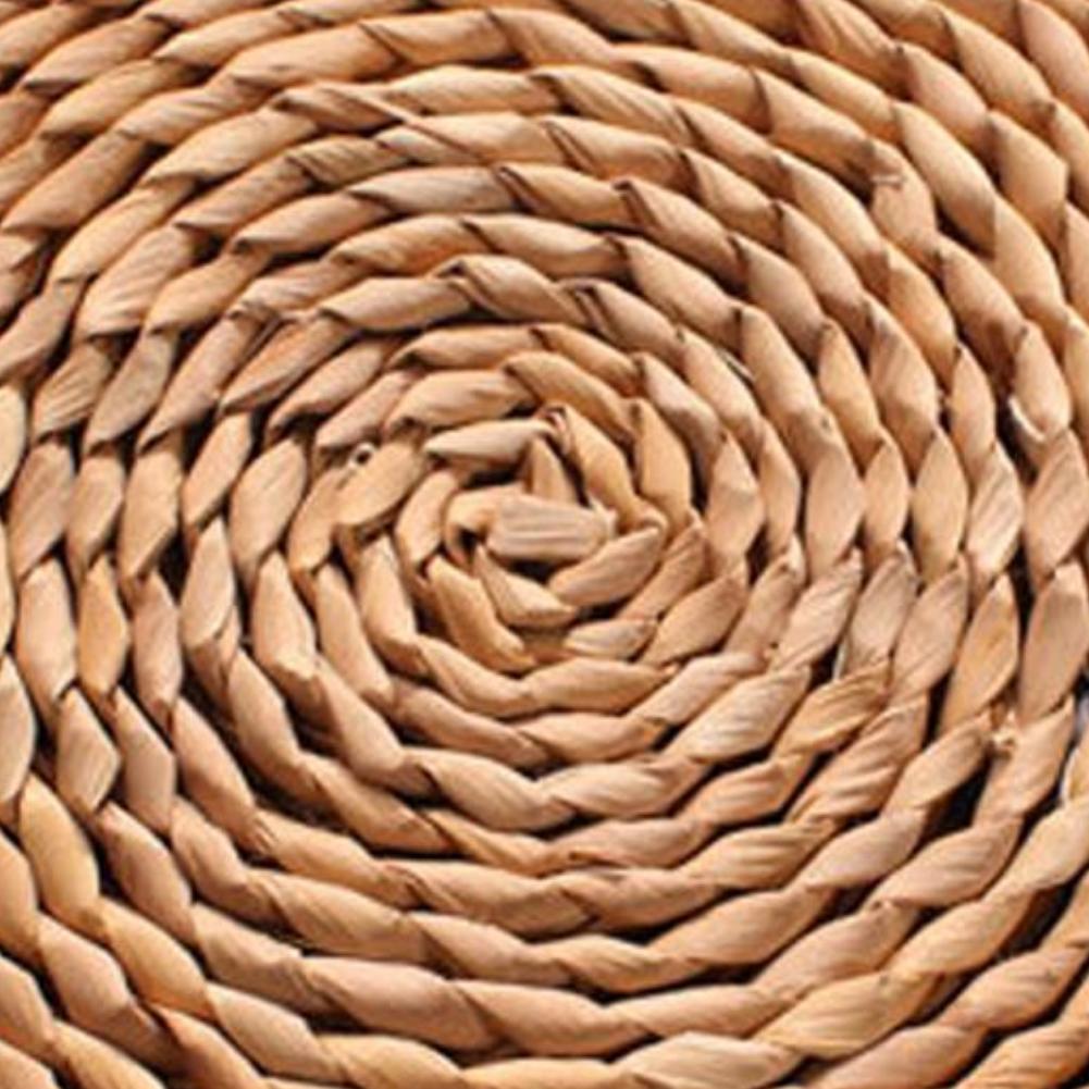 Round dark hand-braided rattan cushion – close-up detail