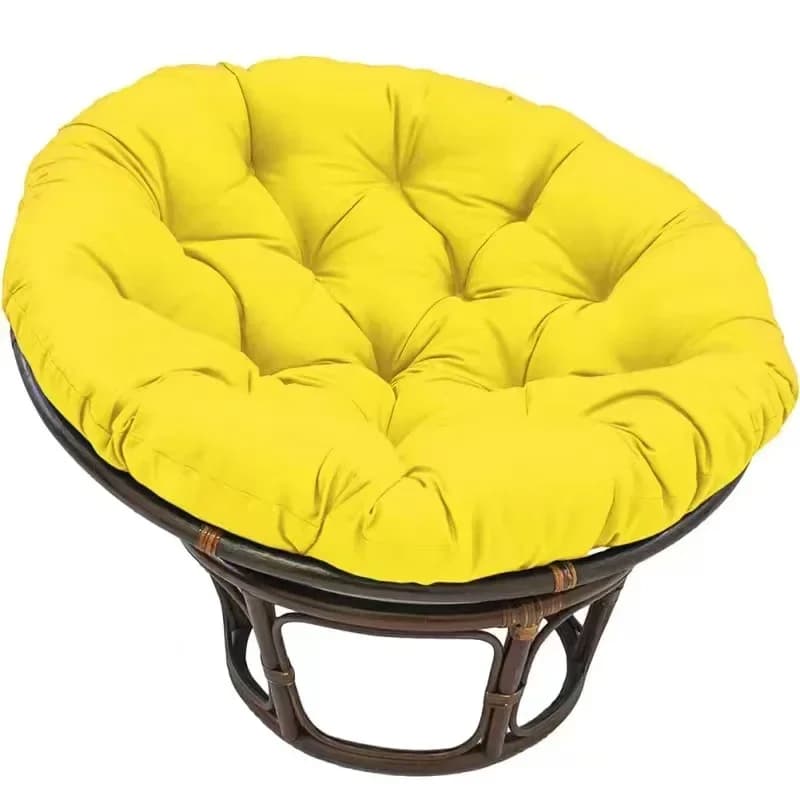 Thick pouf-style plush cushion for a rattan loveseat – yellow variant, shown in a room setting