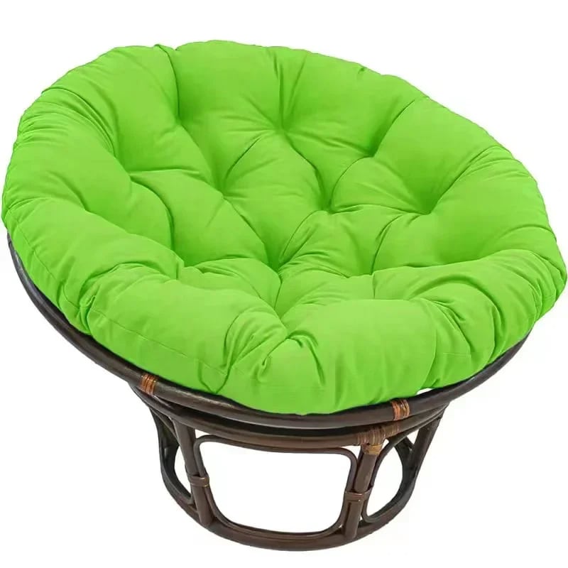 Thick pouf-style plush cushion for a rattan loveseat – green variant, shown in a room setting
