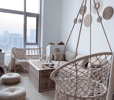 Two round hand-braided rattan wall mirrors in different sizes – shown in a room setting