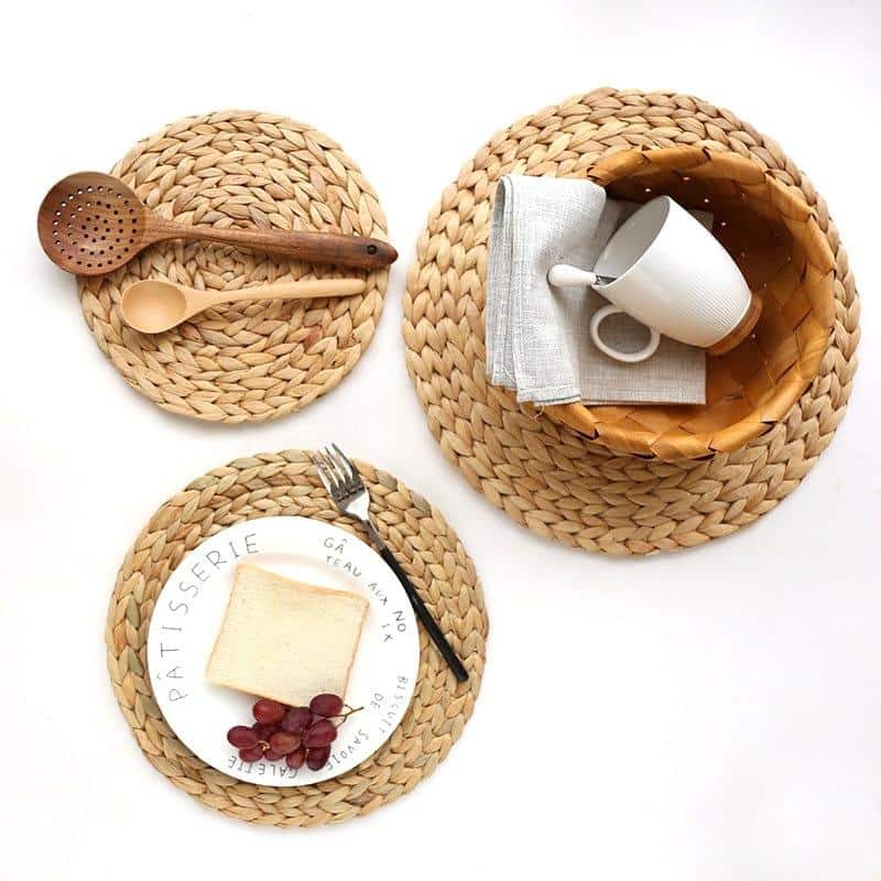 Round woven natural rattan trivet – shown in a room setting