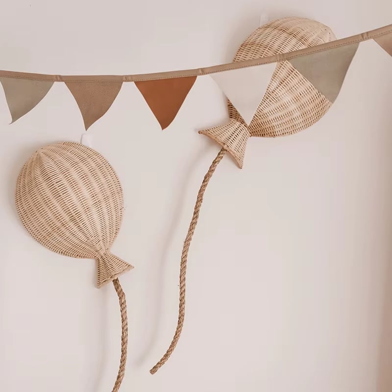 Set of two hand-braided rattan balloon wall decorations – shown in a room setting
