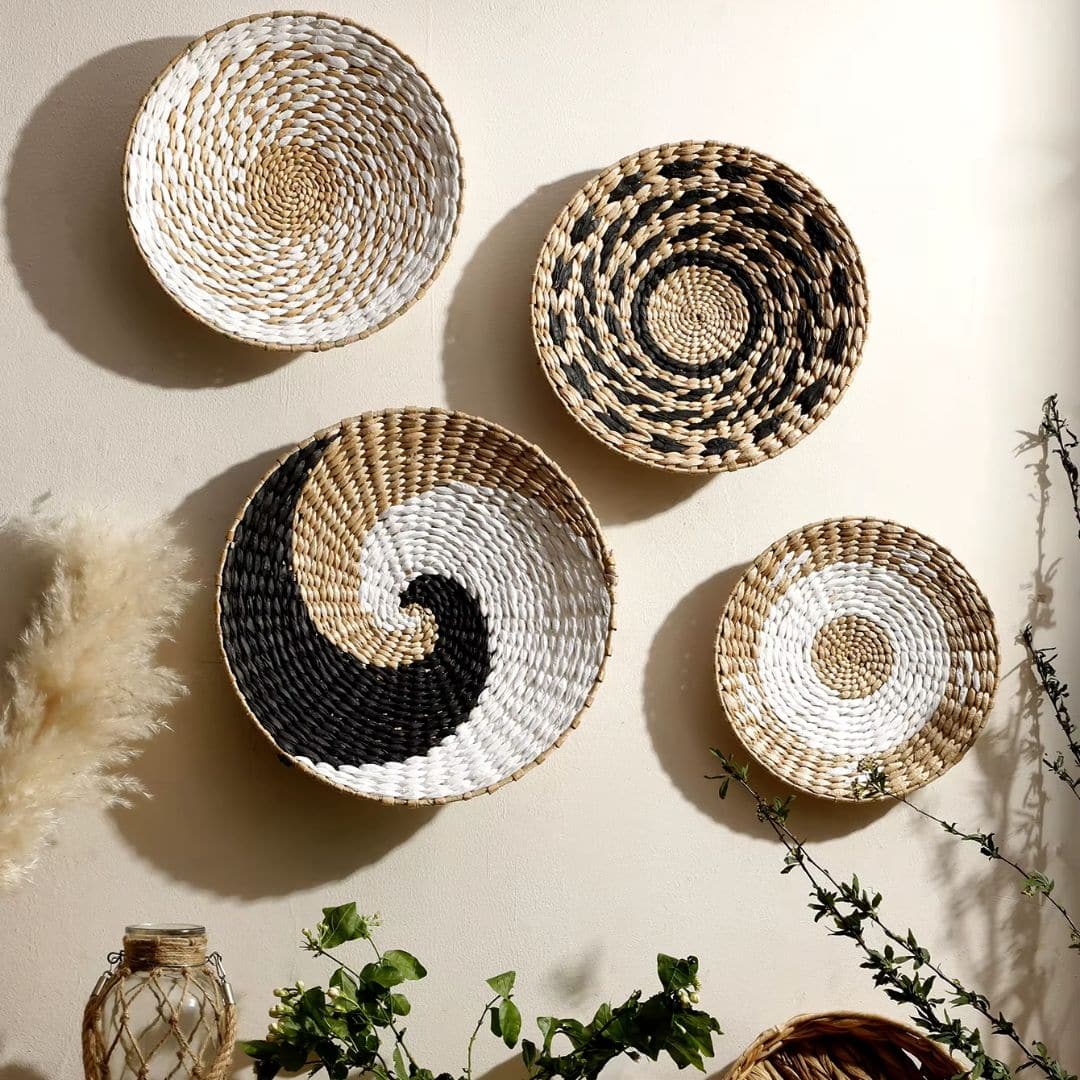 Set of four round hand-woven rattan wall decorations – shown in a room setting