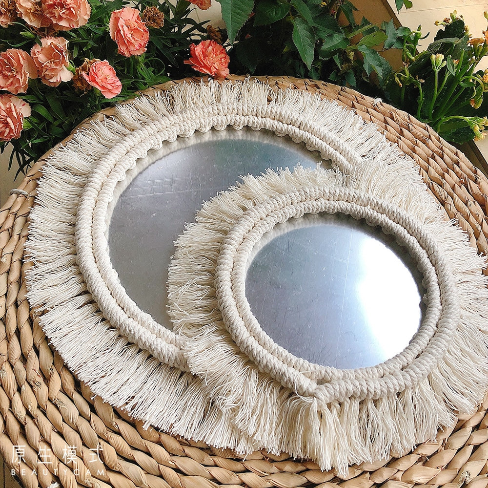 Set of two handwoven golden rattan mirrors – shown in a room setting