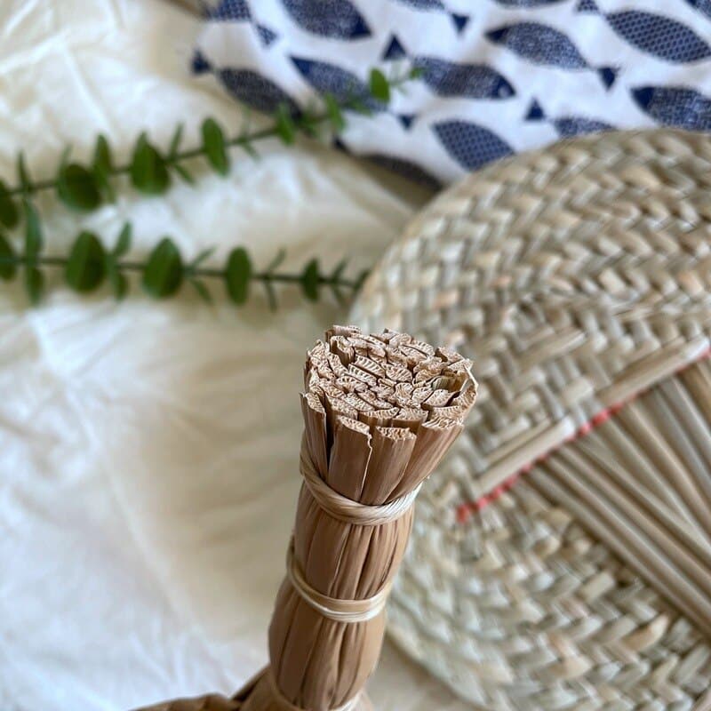 Round hand-woven rattan hand fan – shown in a room setting (2)