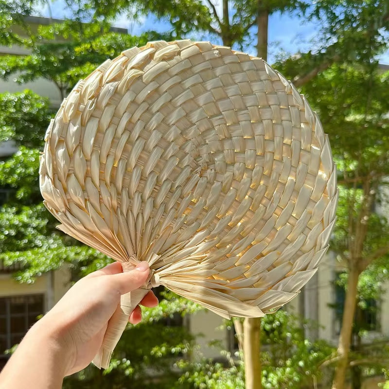 Retro half-circle rattan fan with a knotted handle – shown in use (2)
