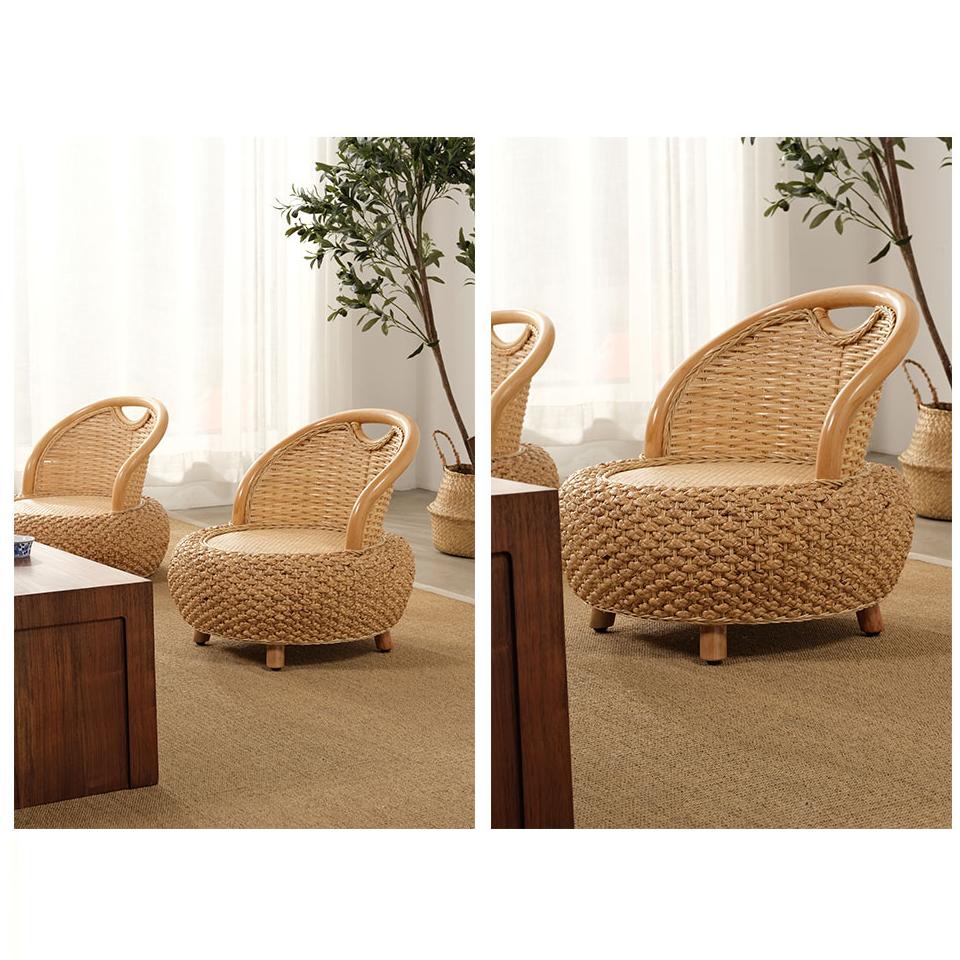 Low beige rattan armchair with rounded arms – shown in a room setting