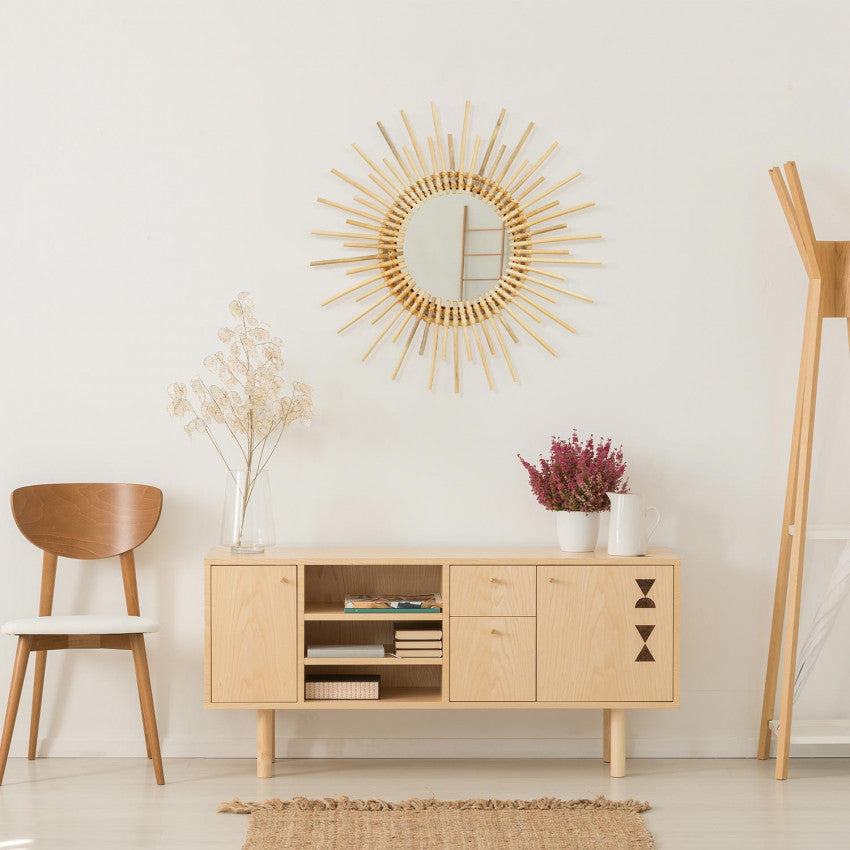 Large radiant hand-braided rattan sunburst mirror – shown in a room setting