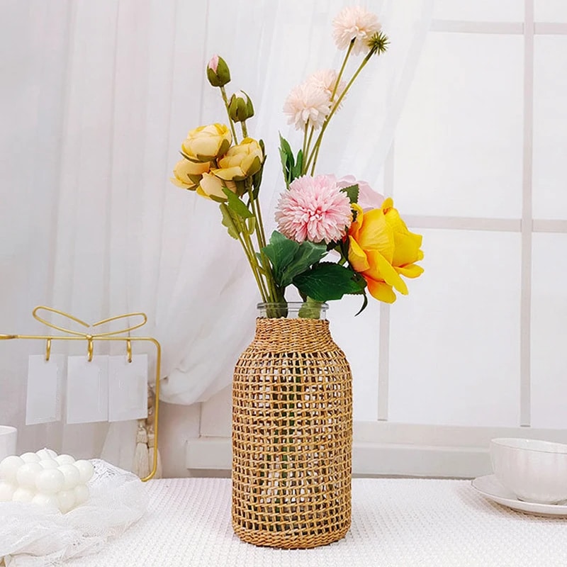 Handwoven wicker vase with a clear glass insert – shown in a room setting
